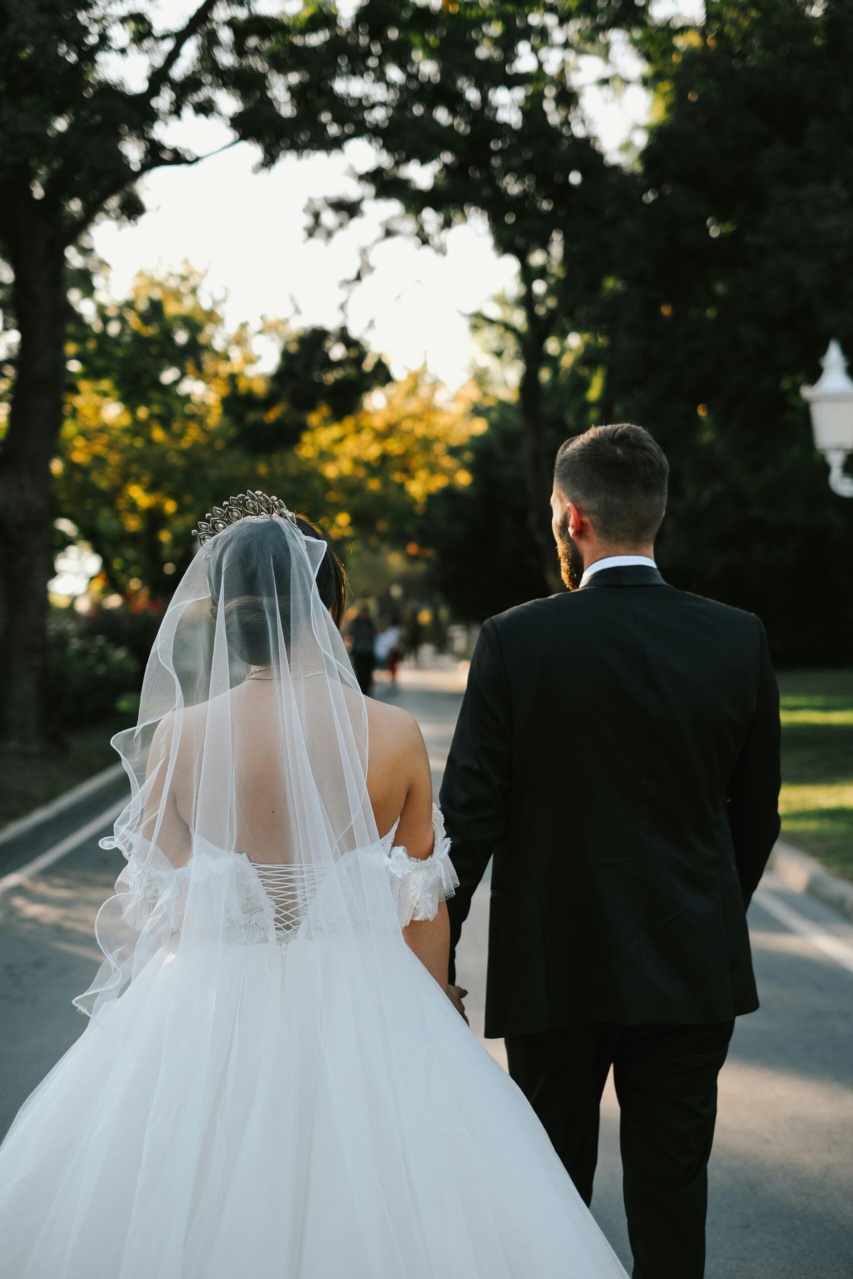 Bride and groom embrace on a boat during a sunny wedding day.
